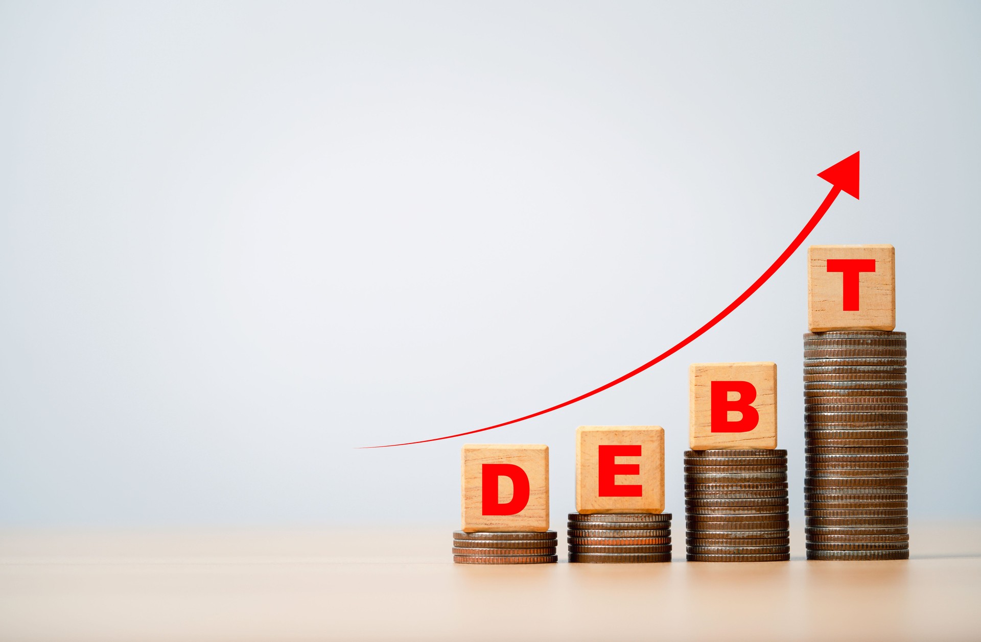 Debt wording on increasing coins stacking and up arrow for business consumer burden financial debt or borrow mortgage failure and government crisis concept.